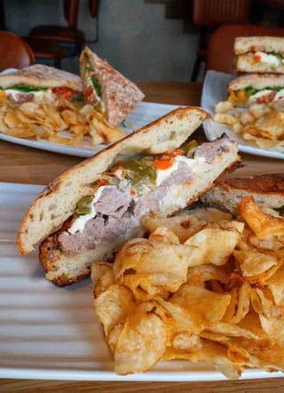 Braised Short Rib Panini cut in half with chips