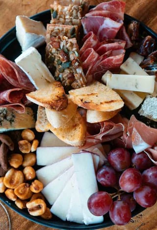 Charcuterie Board with cured meats, cheese, grapes and bread
