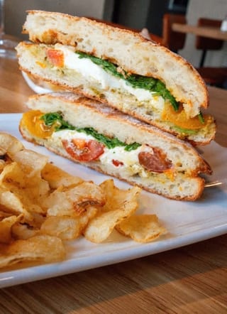 Garden Pesto panini with tomatoes, cheese and greens